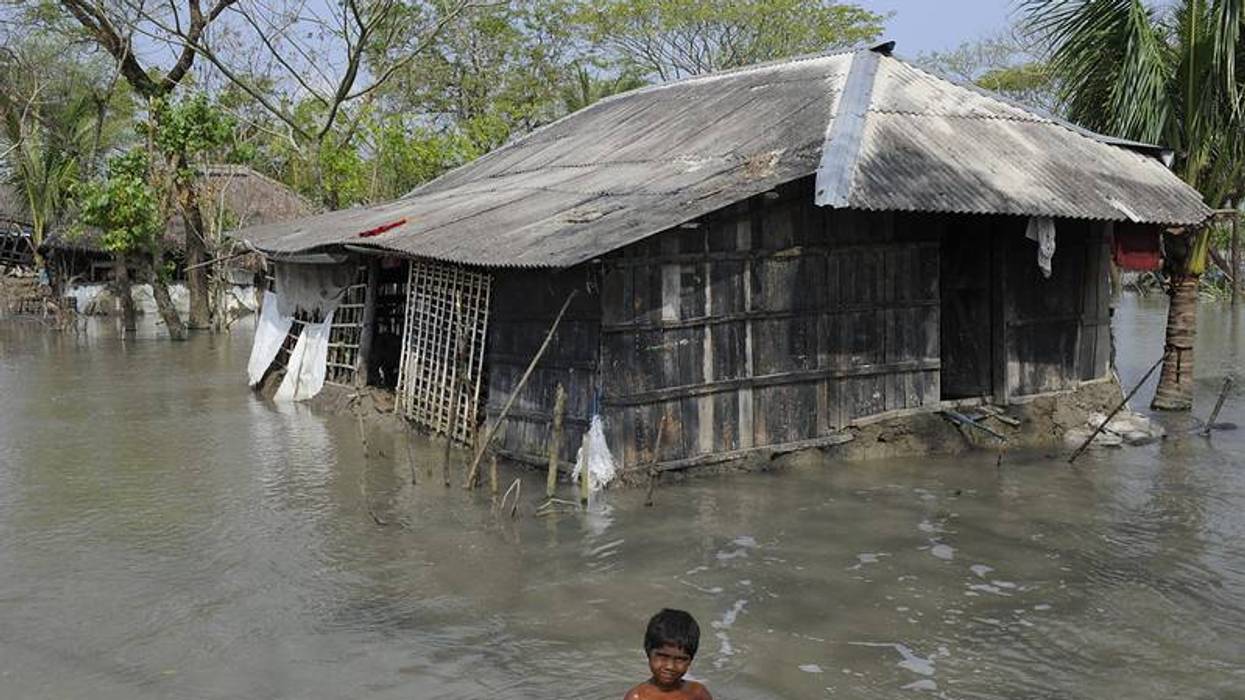 Child in floodwaters.