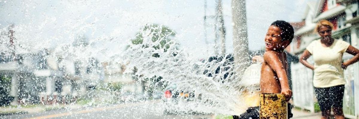 Child playing in water from a fire hydrant