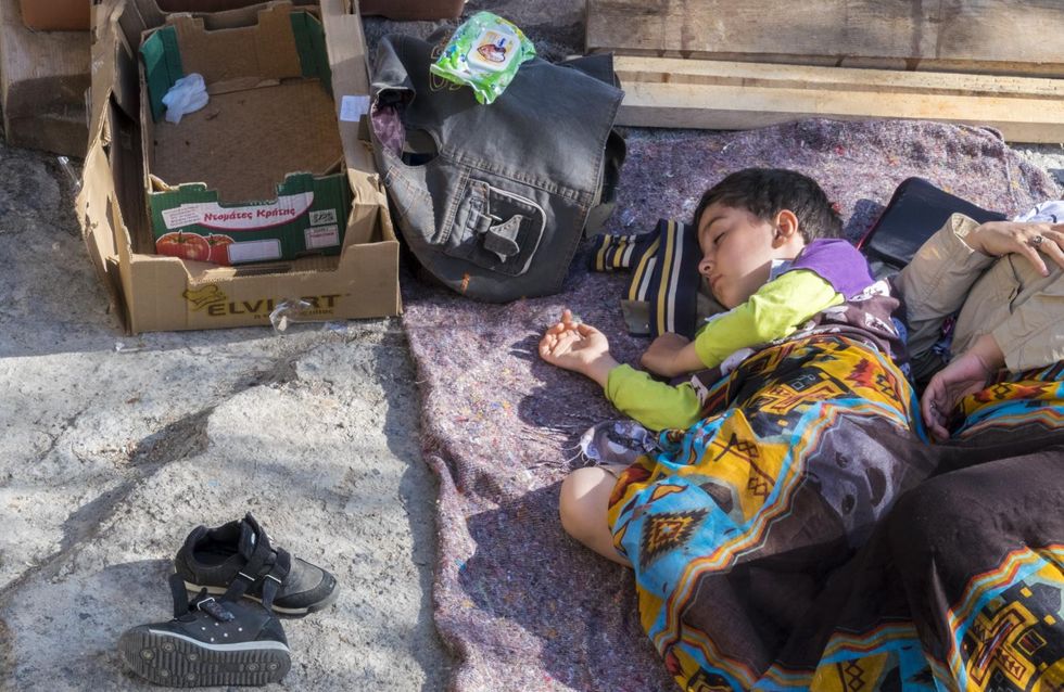 Child sleeping in a makeshift outdoor camp on the Greek island of Lesvos, 2015. (c) Michael S Honegger