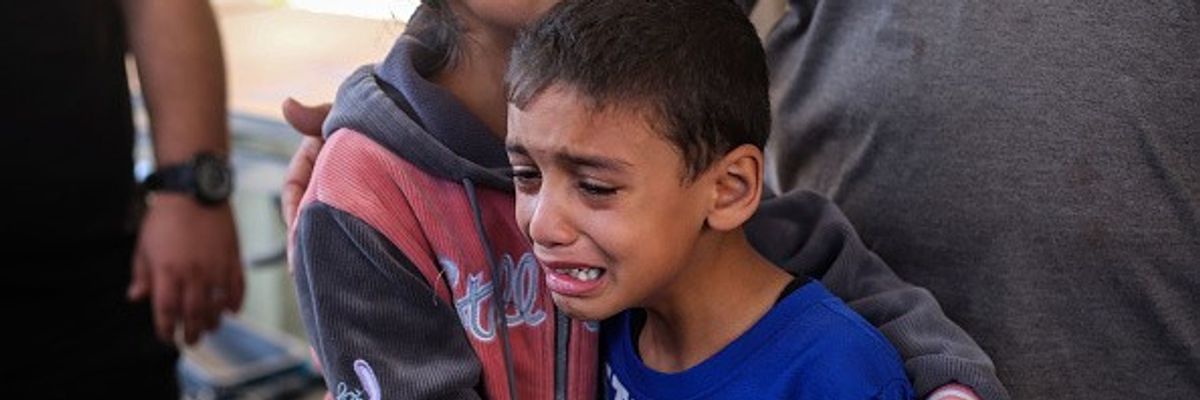 Children are seen crying because of Israeli raids