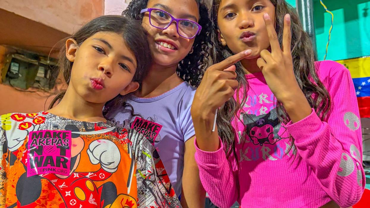Children at the El Panal Commune in Caracas flash the Maduro victory sign.