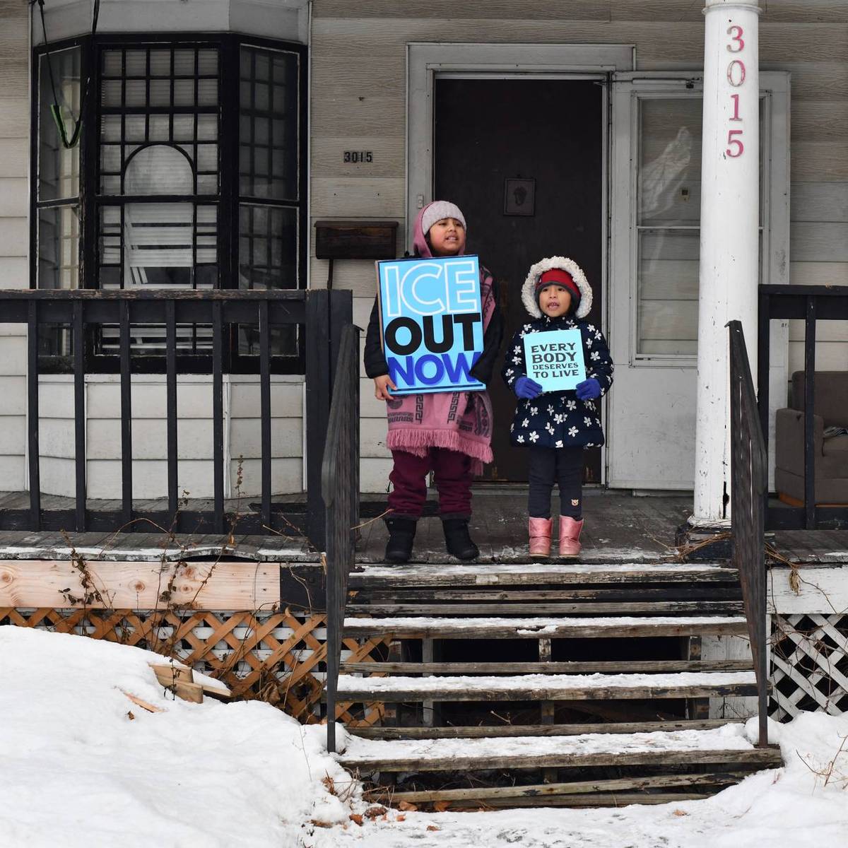 Children held signs as protesters marched in Minneapolis against Immigration and Customs Enforcement