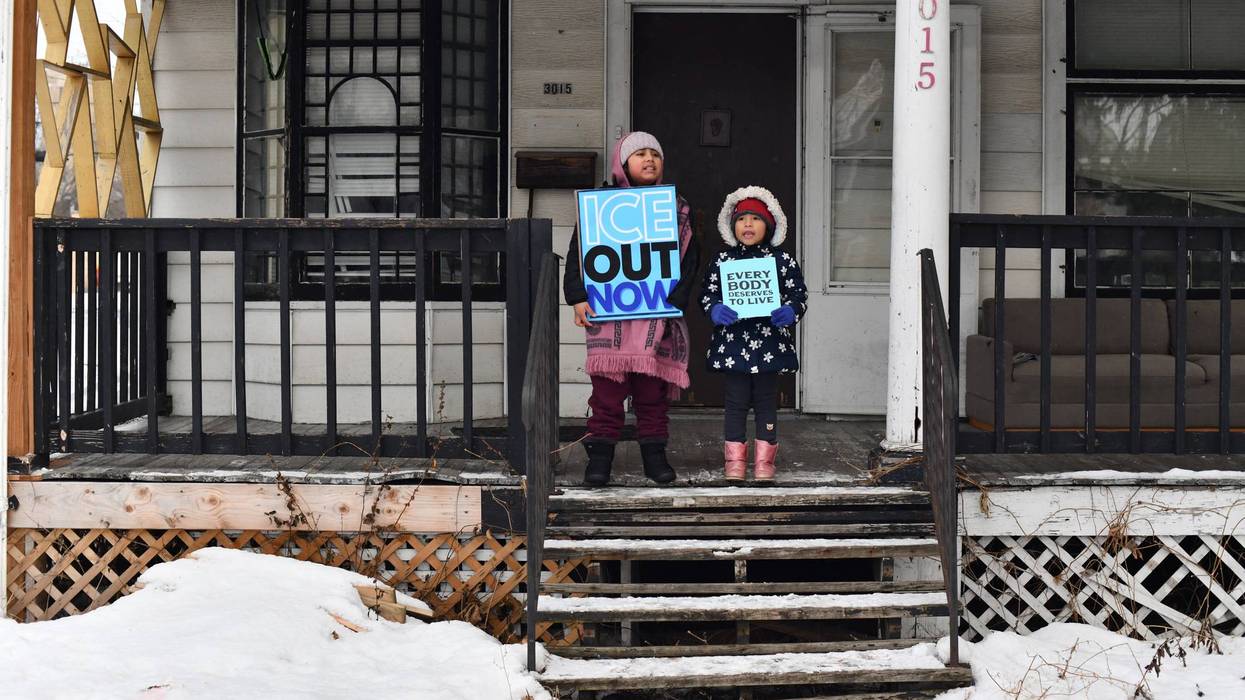 Children held signs as protesters marched in Minneapolis against Immigration and Customs Enforcement
