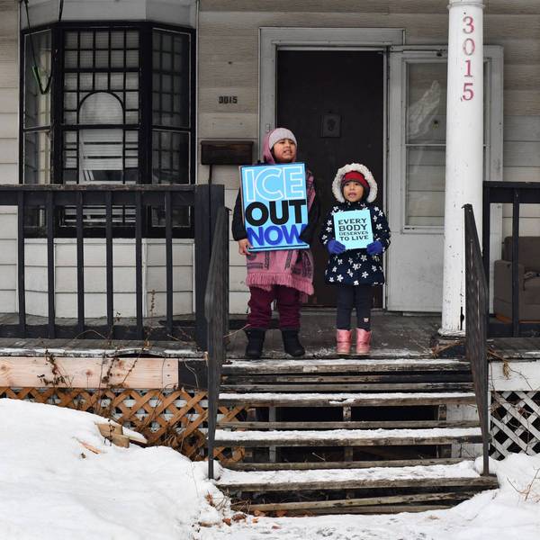 Children held signs as protesters marched in Minneapolis against Immigration and Customs Enforcement