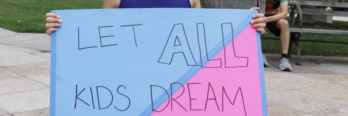 Children holding placards supporting trans children, during