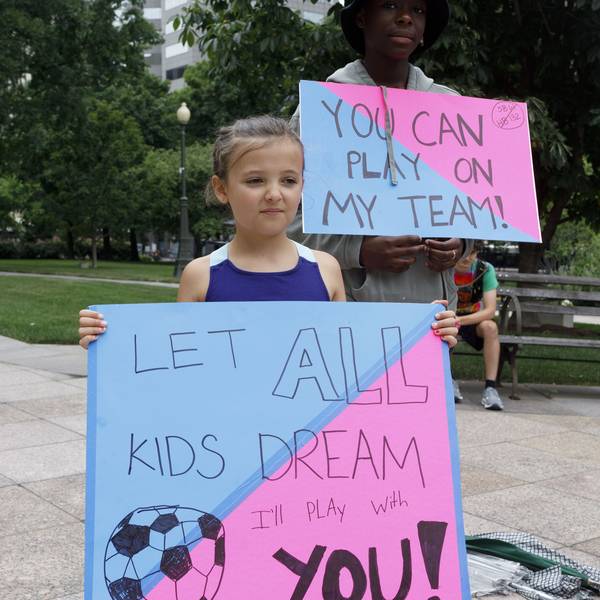 Children holding placards supporting trans children, during