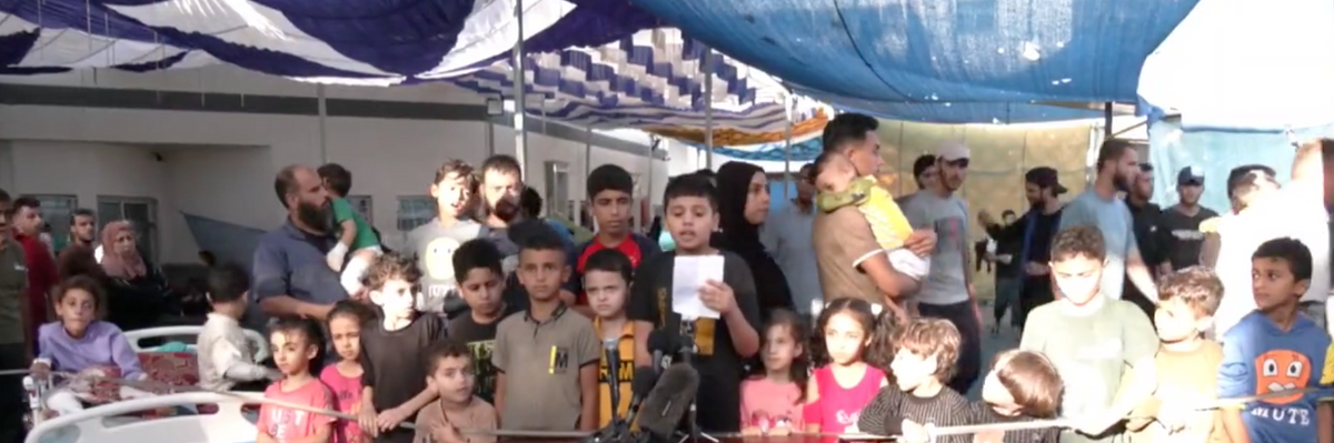 Children in Gaza hold a press conference outside the Al-Shifa Hospital