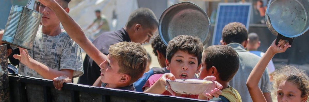 Children in Gaza receiving food rations