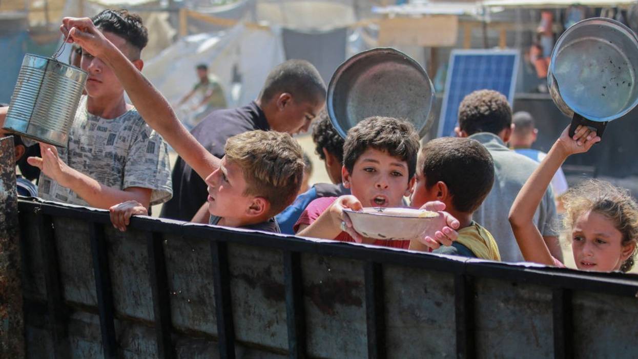 Children in Gaza receiving food rations