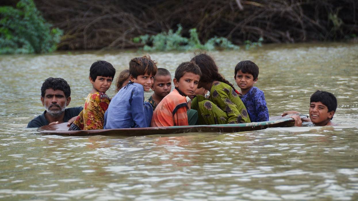 Children in Pakistan face flood waters