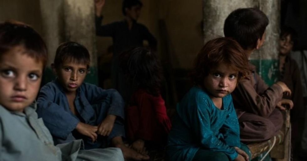 Children play inside the remains of an old Soviet hotel where they have been living for the past two years, on July 15, 2017 in Rodat District, Afghanistan. (Photo: Andrew Renneisen/Getty Images)