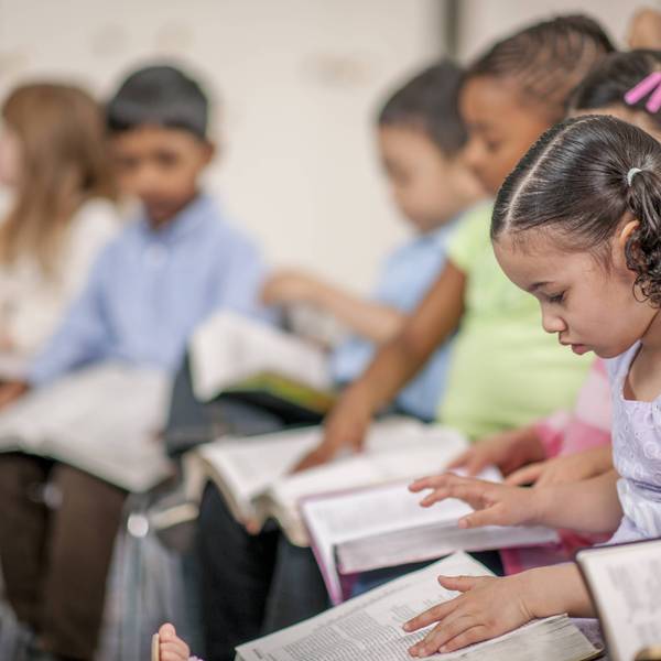 Children read bibles in class