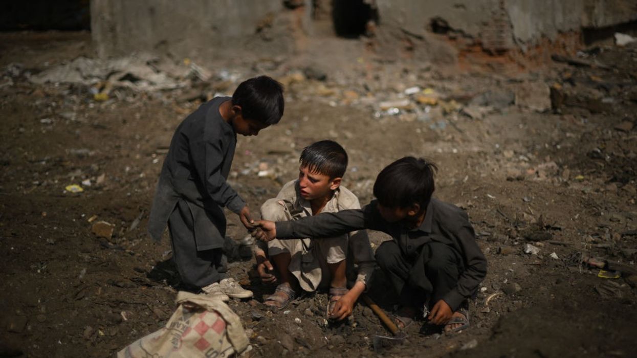 Children scavenge scrap metals in Kabul on July 26, 2022.