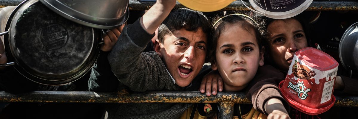 Children wait for food in Rafah.