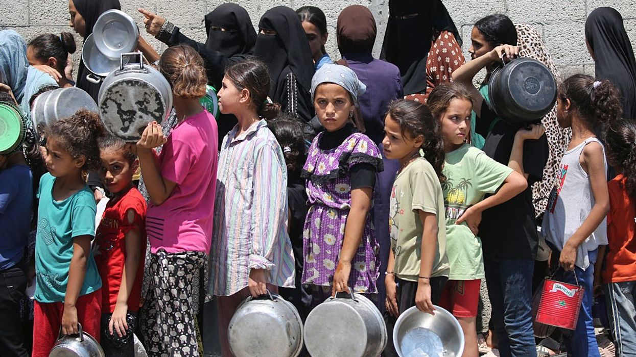 Children wait in a food line in Gaza