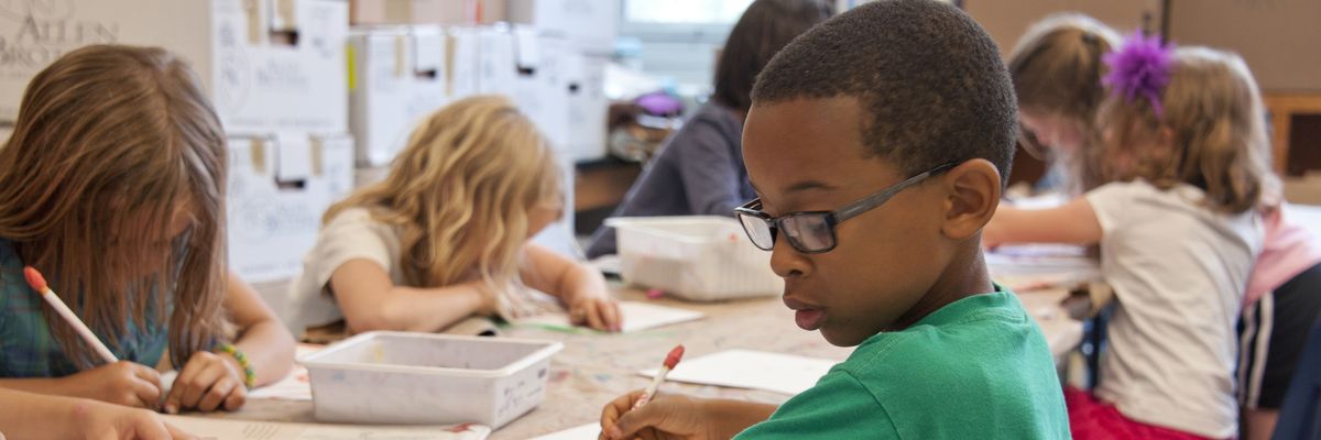 Children work in a classroom.