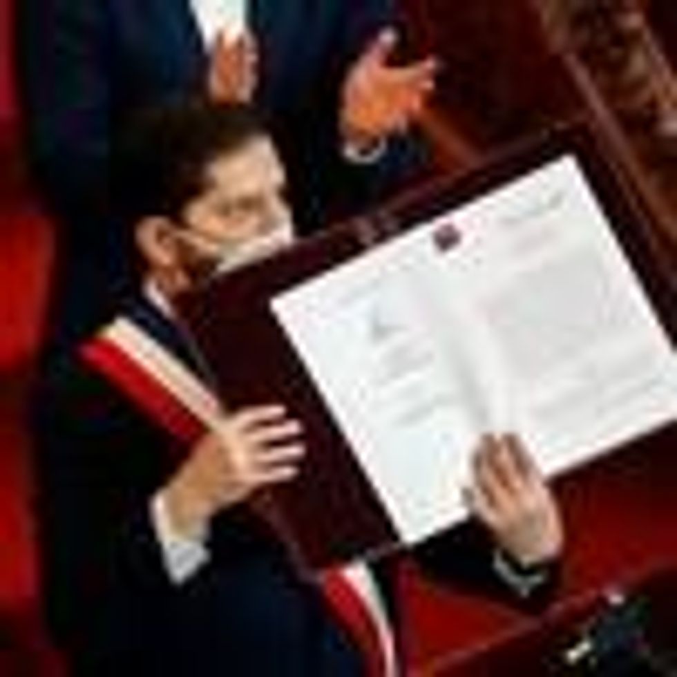 Chile's President Gabriel Boric holds the country's draft Constitution