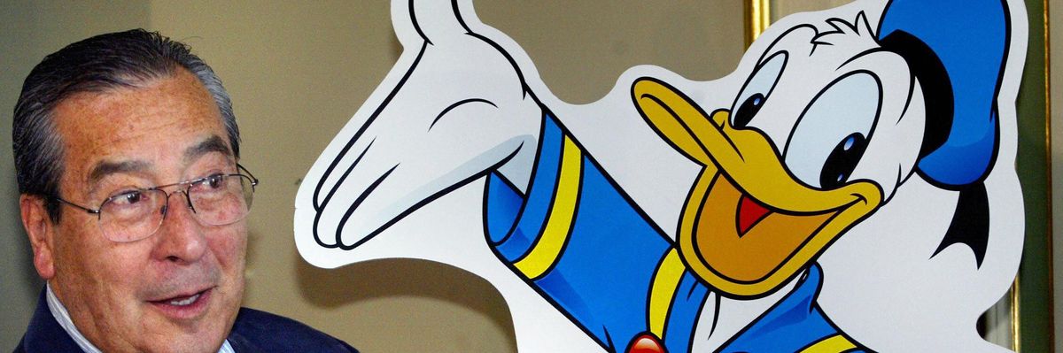 Chilean comic-strip artist Victor Arrigada Rios (Vicar) stands beside a Donald Duck