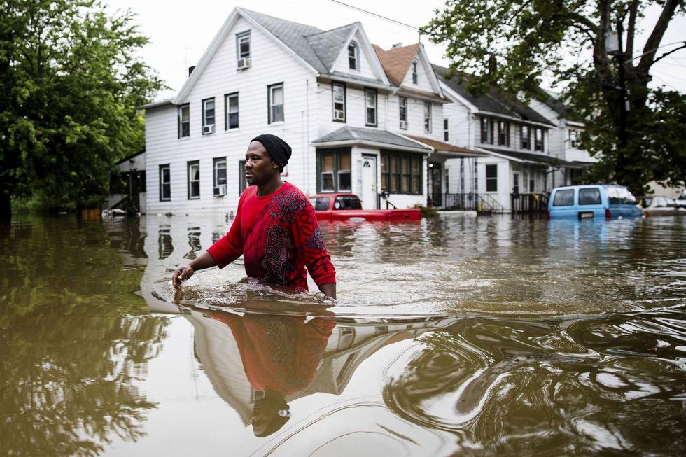 Chris Smith makes his way through floodwaters to the Macedonia Baptist Church in Westville, N.J., Thursday, June 20, 2019. Severe storms with heavy rains and strong winds spurred flooding across southern New Jersey, disrupting travel and damaging some property. (AP Photo/Matt Rourke)