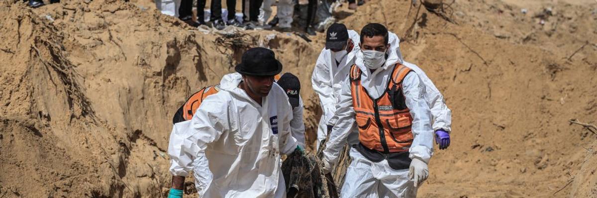 Civil Defense Authority teams remove bodies of Palestinians
