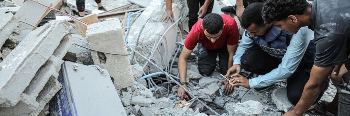 Civil defense teams and residents carry out search and rescue