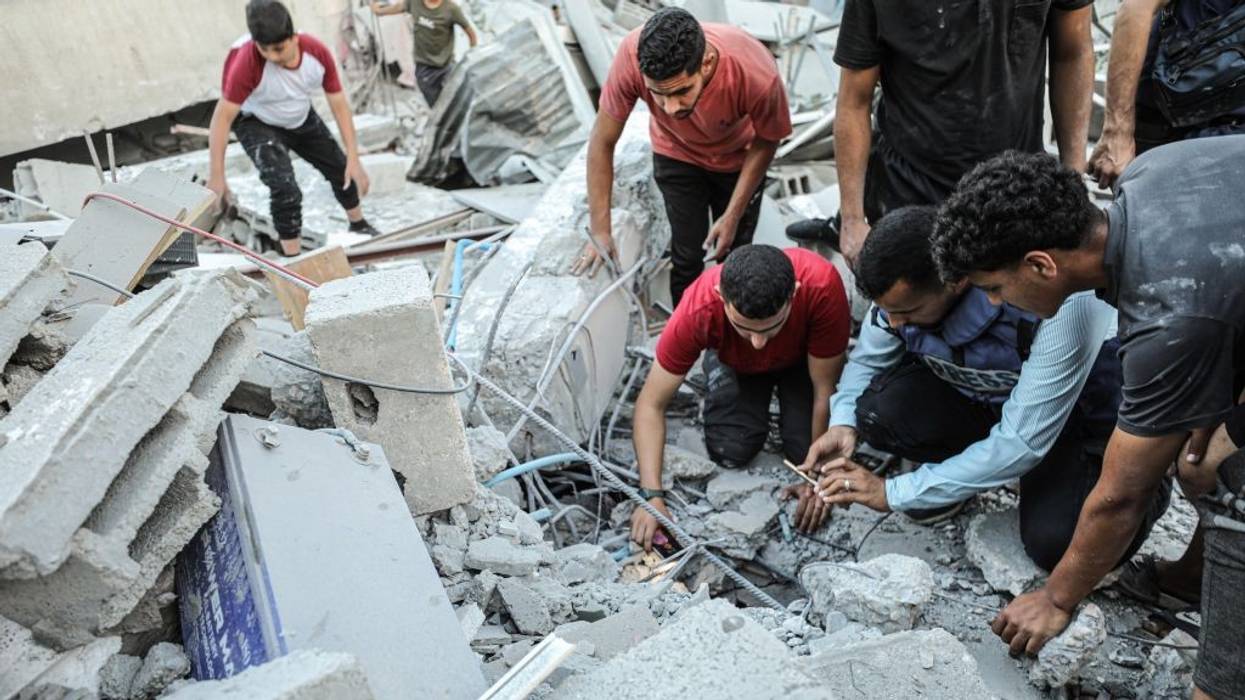 Civil defense teams and residents carry out search and rescue