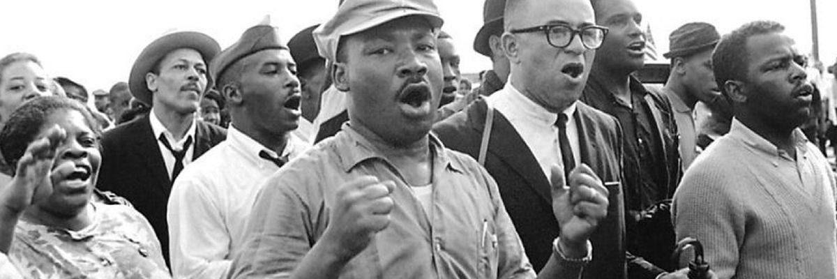 Civil rights activists  led by Dr. Martin Luther King sing as they march from Selma to Montgomery in 1965. 