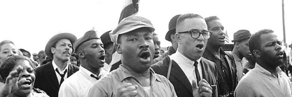 Civil rights activists  led by Dr. Martin Luther King sing as they march from Selma to Montgomery in 1965. 