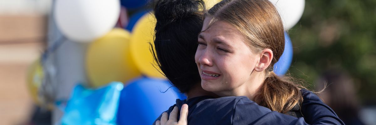 Classmates at Georgia's Apalachee High School embrace after shooting that left four dead