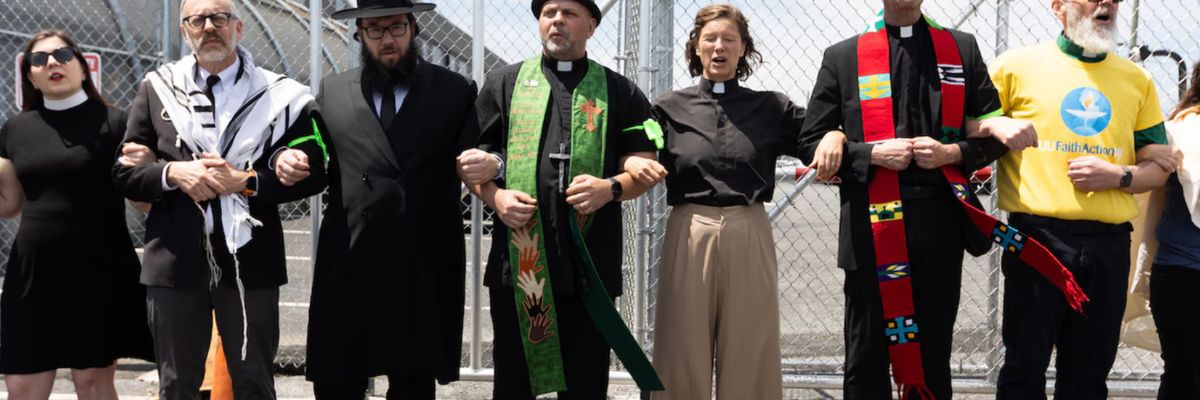 Clergy members link arms outside Newark ICE facility