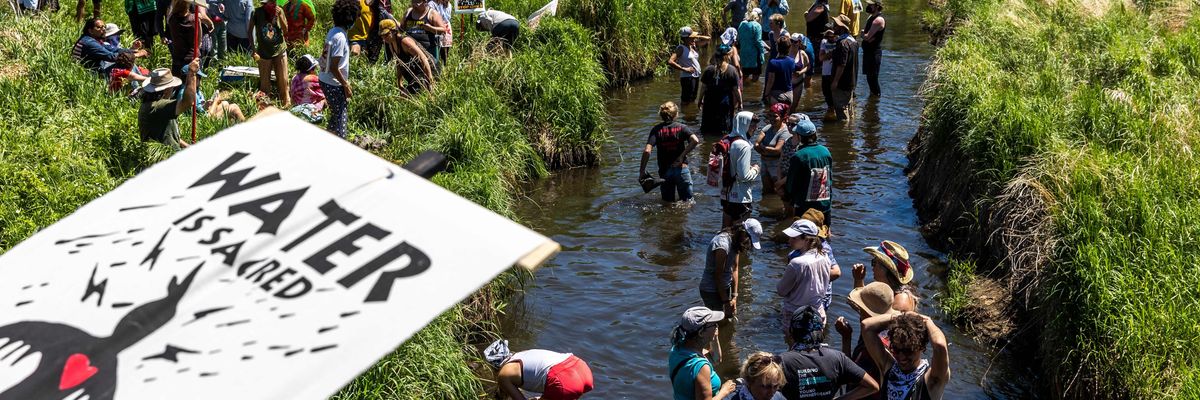 Climate activists and Indigenous community members gather on the river for a traditional water ceremony during a rally and march to protest the construction of Enbridge Line 3 pipeline