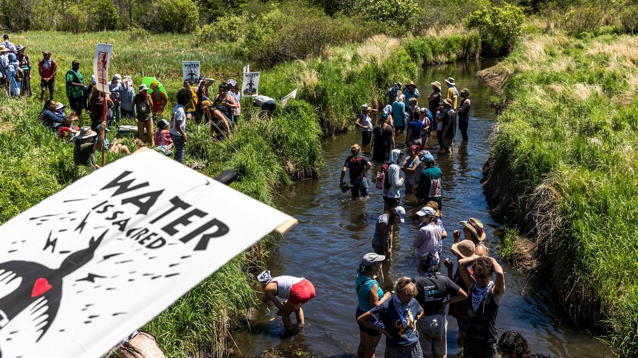 Climate activists and Indigenous community members gather on the river for a traditional water ceremony during a rally and march to protest the construction of Enbridge Line 3 pipeline
