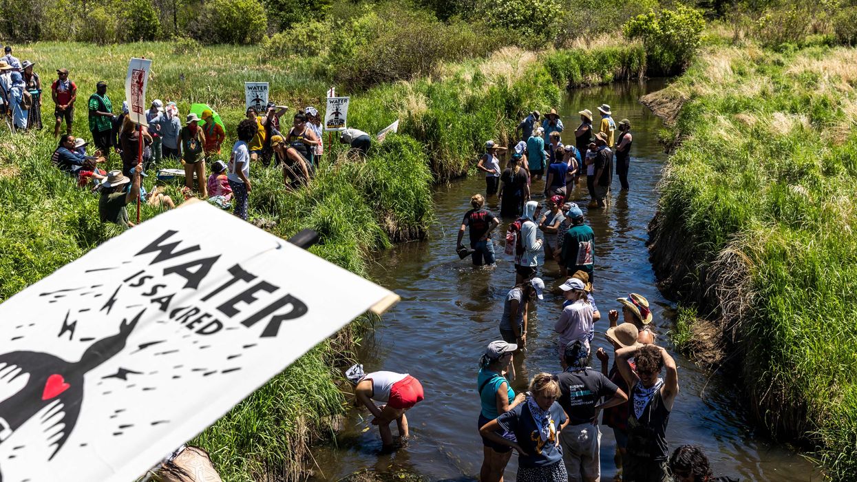 Climate activists and Indigenous community members gather on the river for a traditional water ceremony during a rally and march to protest the construction of Enbridge Line 3 pipeline