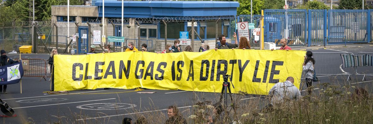 Climate activists demonstrate outside the gates of the Mossmorran petrochemical refinery near Cowdenbeath, Scotland on August 1, 2021. (Photo: Jane Barlow/PA Images via Getty Images)