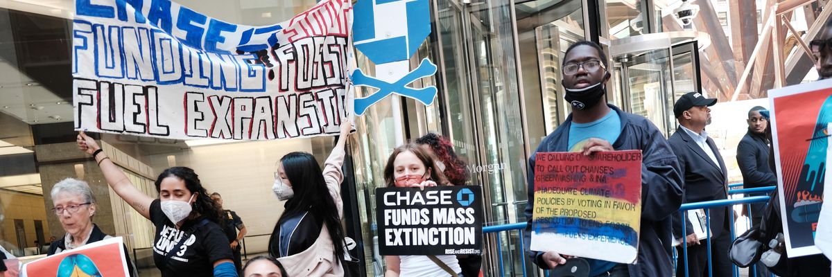 Climate activists demonstrate outside the headquarters of JPMorgan Chase during the bank's annual shareholder meeting on May 17, 2022 in New York City.