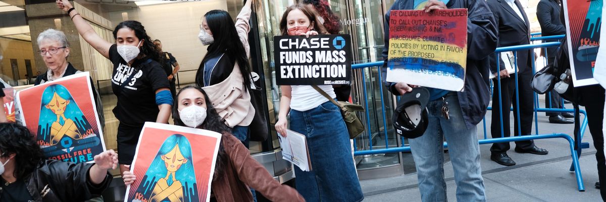 Climate activists demonstrate outside the headquarters of JPMorgan Chase during the bank's annual shareholder meeting on May 17, 2022 in New York City.