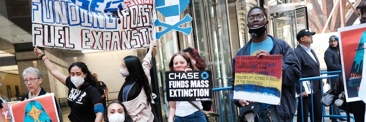 Climate activists demonstrate outside the headquarters of JPMorgan Chase during the bank's annual shareholder meeting