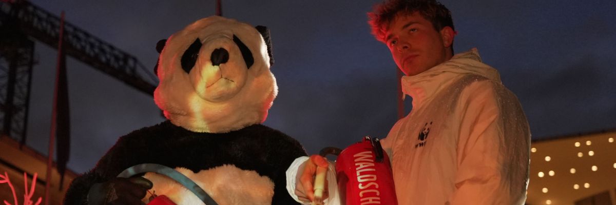 Climate activists hold fire extinguishers.