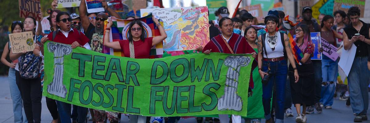 Climate activists march over Brooklyn Bridge.