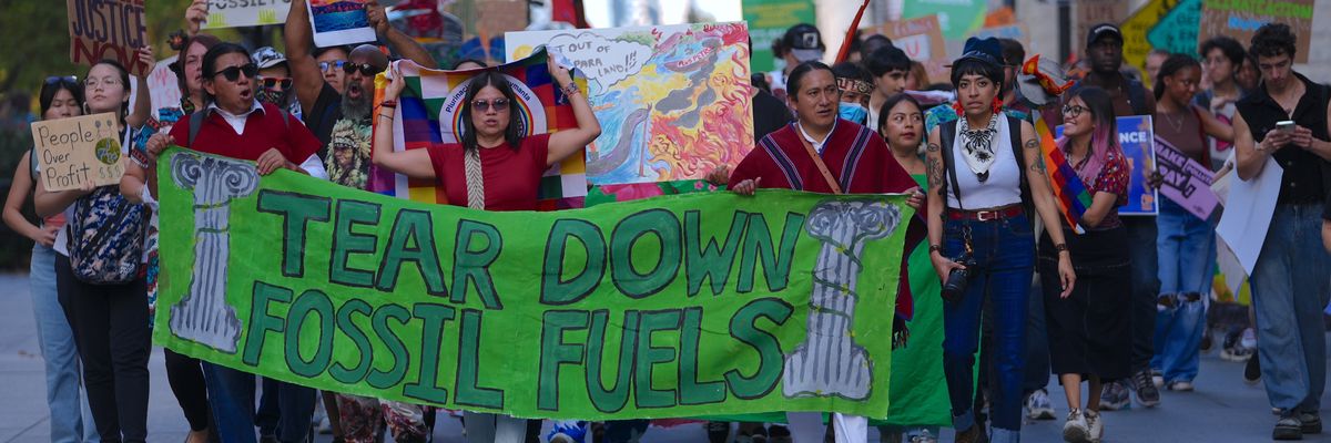Climate activists march over Brooklyn Bridge.