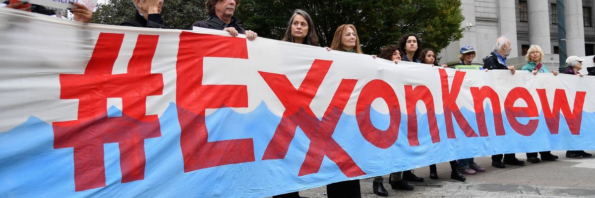 Climate activists protest during the Exxon trial