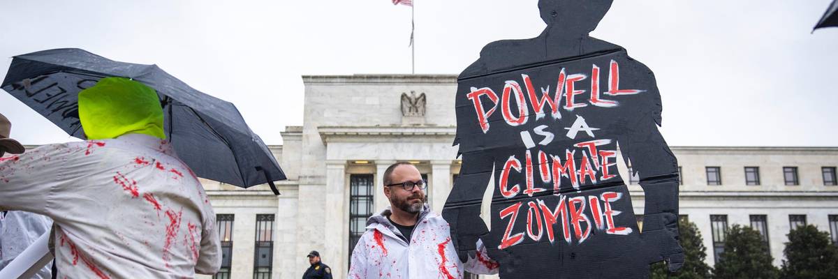 Climate activists protest Fed Chair Jerome Powell.