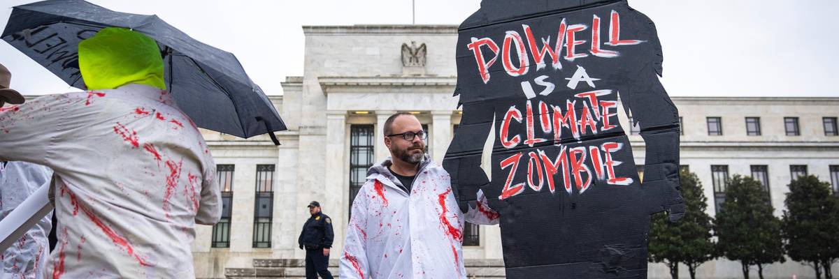 Climate activists protest Fed Chair Jerome Powell.