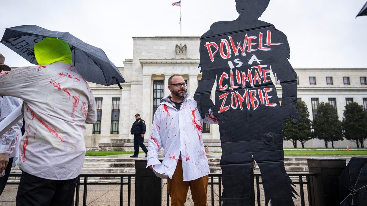 Climate activists protest Fed Chair Jerome Powell.