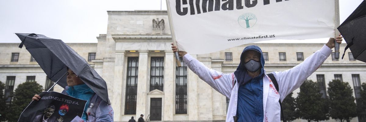 Climate activists rally against Federal Reserve Chair Jerome Powell outside of the Federal Reserve Board Building October 29, 2021 in Washington, DC