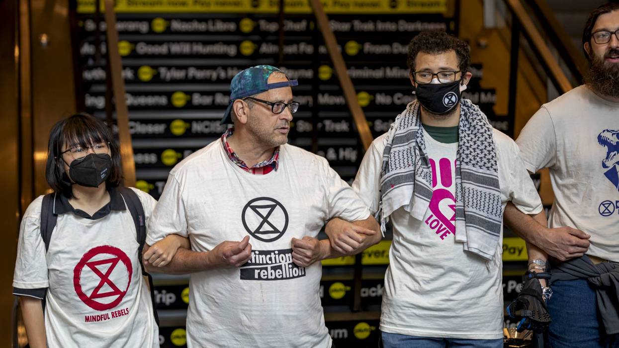 Climate activists with Extinction Rebellion block escalators...