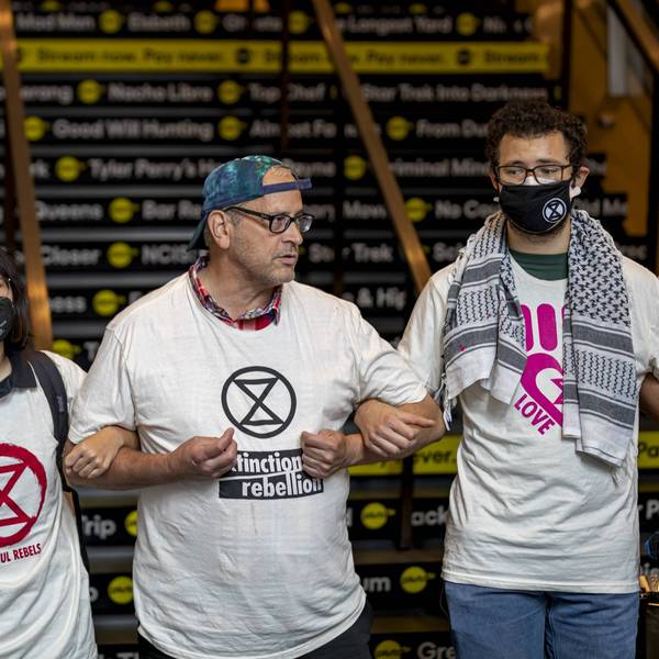 Climate activists with Extinction Rebellion block escalators...