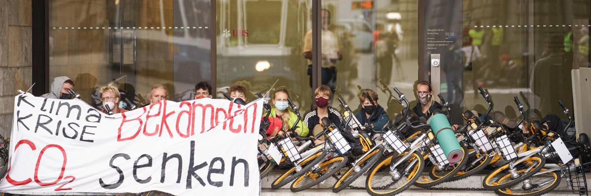 Climate justice activists occupied the center of Zürich's financial district on August 2, 2021 to demand that the two biggest banks in Switzerland divest from oil, gas, and coal. (Photo: Rise Up for Change/flickr/cc)