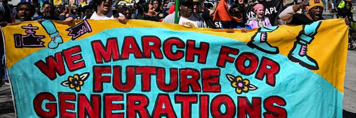 Climate protest sign says "We March for Future Generations"