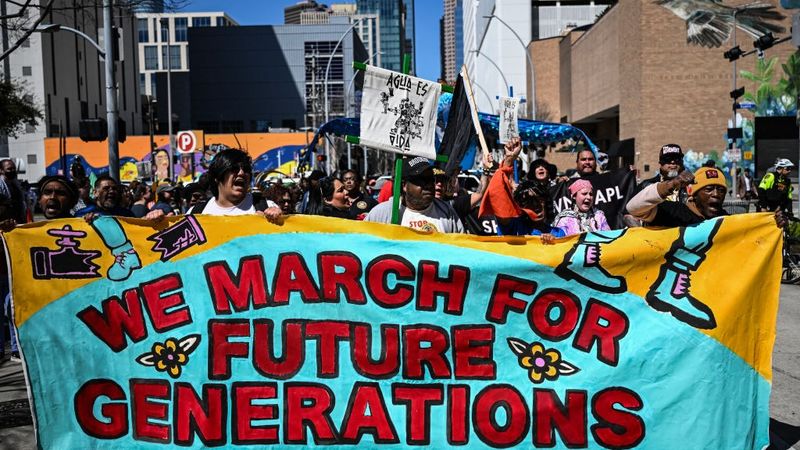 Climate protest sign says "We March for Future Generations"